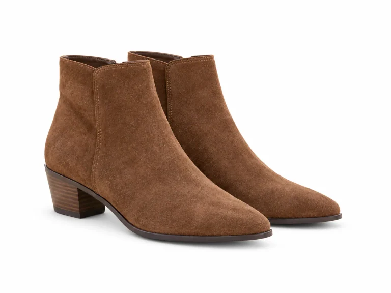 The same pair of brown suede ankle boots showing both soles, isolated against a plain white background.